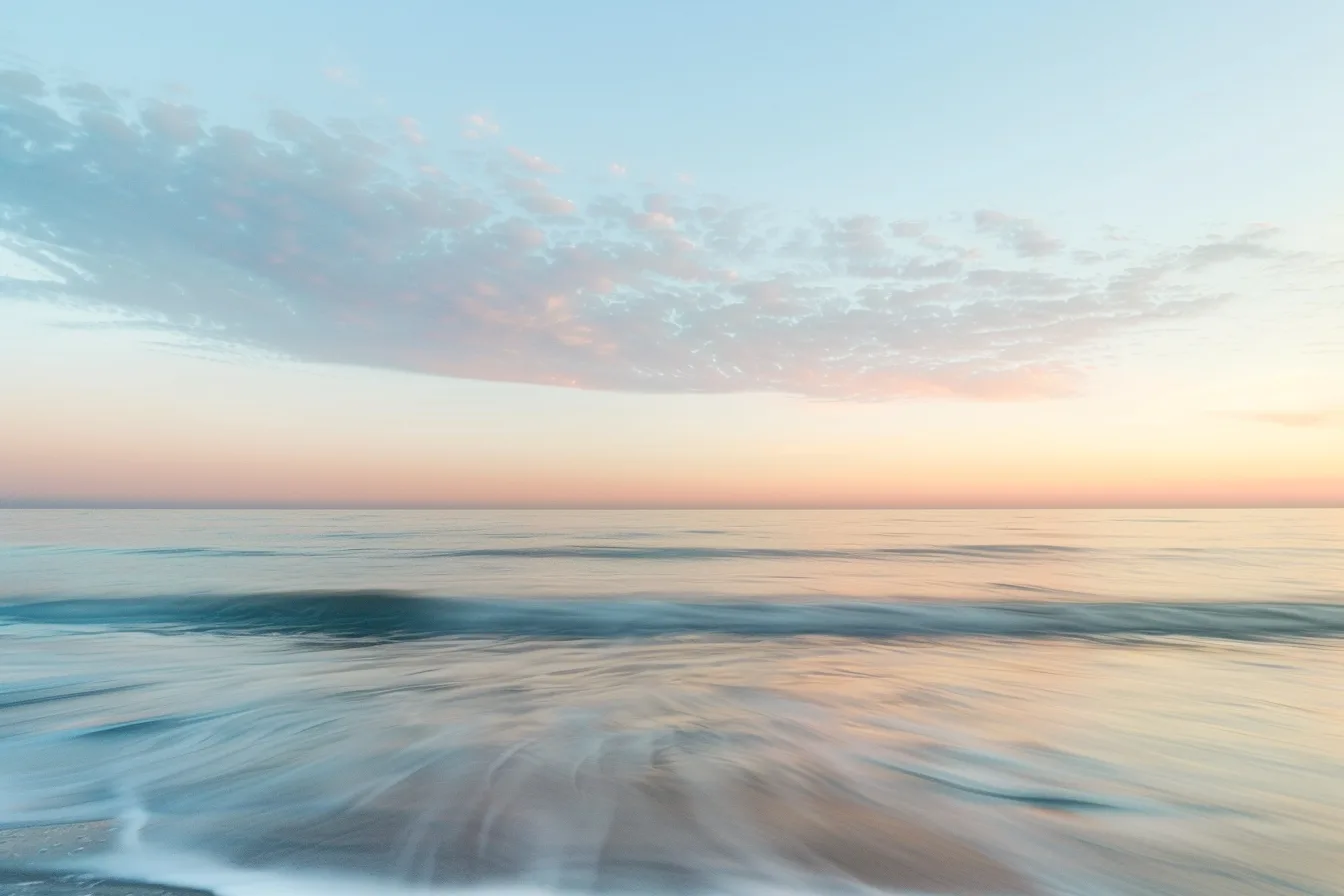 Minimal pastel seascape with a low wave and soft blue and peach horizon